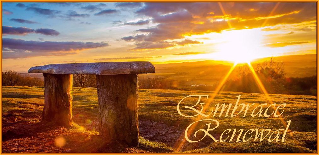 A rustic hillside bench with sunrise over the valley